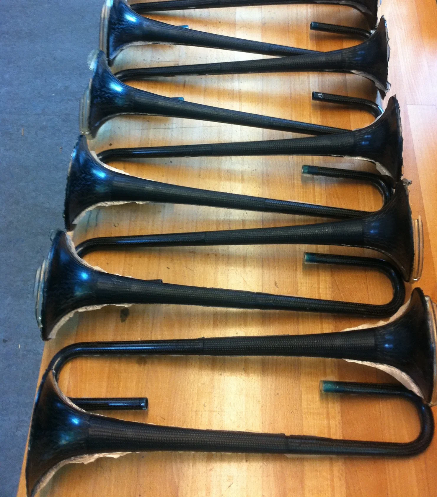 Finished carbon bells lined up on the workbench